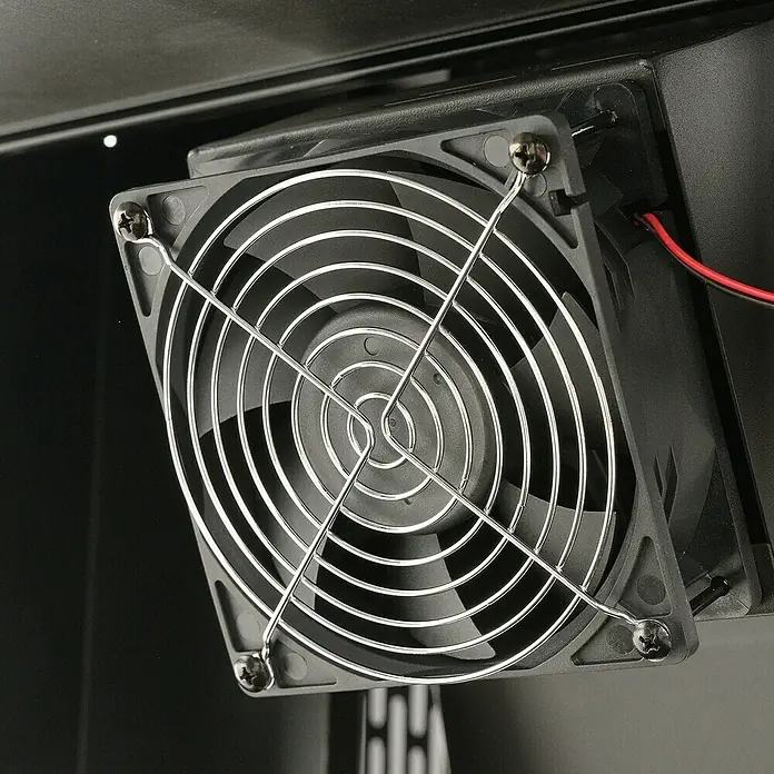 Masterbuilt Holzkohlegrill Gravity 1050 - Grillfläche (B x T): 66 x 49 cm, Schwarz - Ein schwarzer Computerlüfter mit silbernem Drahtgitter, mit Schrauben befestigt, rote und schwarze Kabel sichtbar.