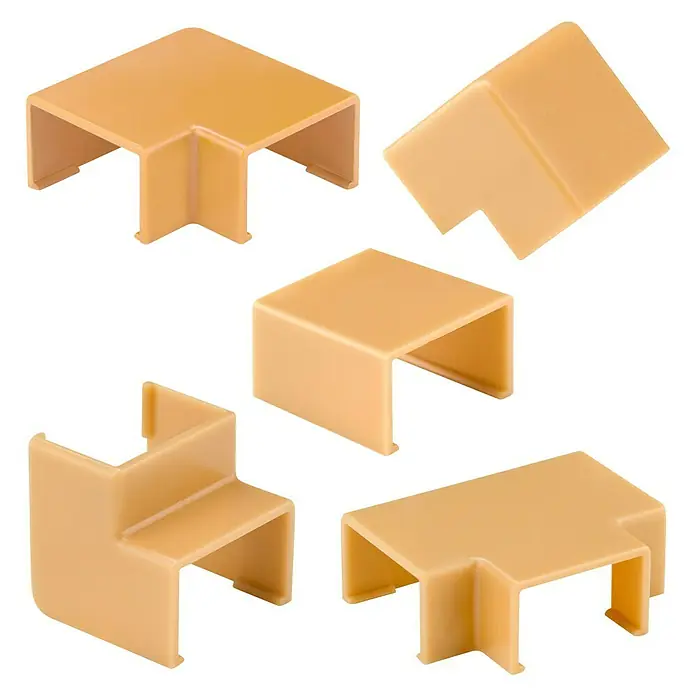 Inofix Plasfix Kit de accesorios para canaleta - Roble, An x Al: 1,6 x 1 cm, 7 ud. - Una imagen detallada de conductos de cable beige y conectores de esquina en varias formas para una gestión limpia de los cables.