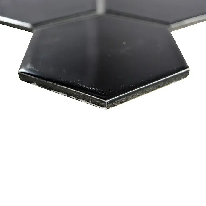 Mosaikfliese Hexagon Uni HX 110 - 25,6 x 29,55 cm, Schwarz, Glänzend - Nahaufnahme von schwarzen, sechseckigen Wandfliesen, die ein elegantes und modernes Design für Innenräume bieten.