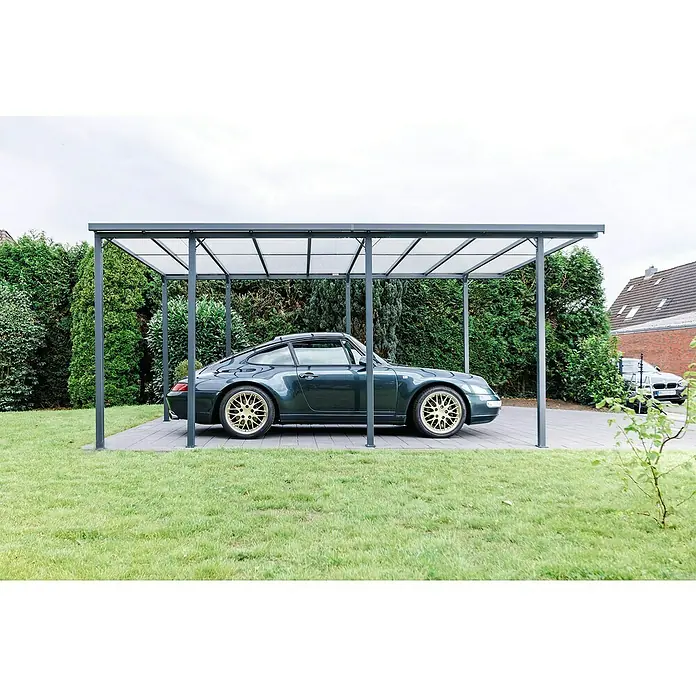 DWS Outdoor Carport Premium L - Außenmaß inkl. Dachüberstand (B x T): 3,31 x 5,41 m, Anthrazit, Carport geeignet für: PKWs - Graues Metall-Carport mit transparentem Dach, schützt ein Auto auf einer gepflasterten Einfahrt.