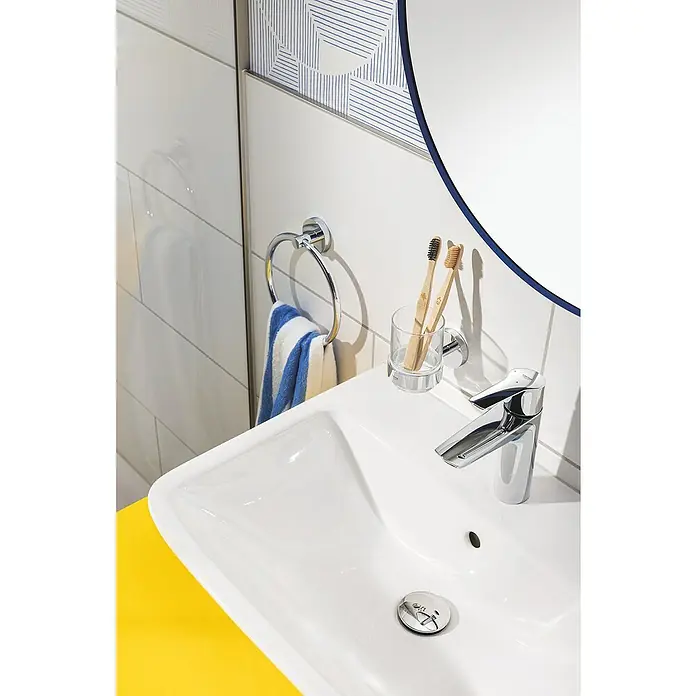 Grohe QuickFix Start Handtuchring - Glänzend - Ein modernes Badezimmerwaschbecken mit Armatur, Handtuchring und Zahnputzbecher. Das Becken ist weiß und die Arbeitsplatte gelb.