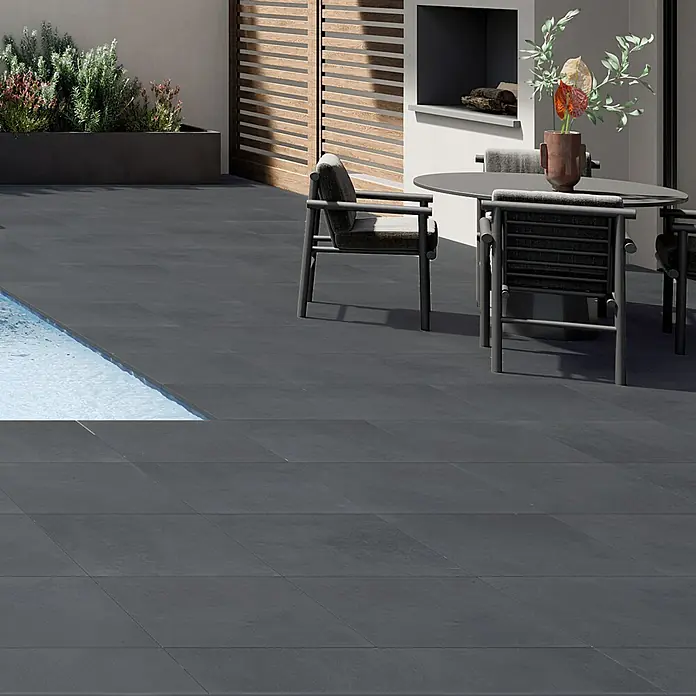 Art-Tec by Palazzo Terrassenfliese60 x 60 x 2 cm, Graphit, Matt - Eine stilvolle Terrasse mit dunklen Fliesen, die einen modernen und eleganten Außenbereich schaffen. Die Fliesen betonen die klaren Linien des Designs.