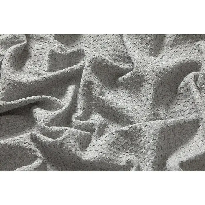 Manta para sofá Multiusos Waffle - Textil, Gris - Primer plano de tela de gofre gris suave en pliegues delicados, mostrando una textura acogedora ideal para textiles del hogar.