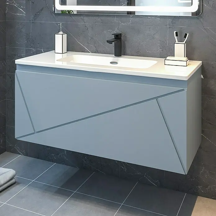 Disbain Conjunto de mueble de baño Lira - Ancho: 100 cm, Azul Soho, Mate, 2 pzs. - Un moderno tocador azul de pared con patrones geométricos y una encimera blanca, mostrando un elemento de diseño de baño elegante.