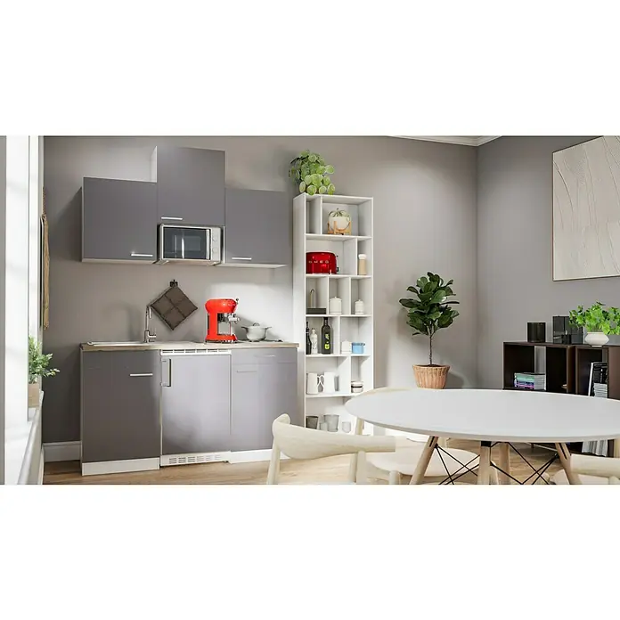 Respekta Singleküche Luis - Breite: 150 cm, Grau, Mit Glaskeramikkochfeld, Mikrowelle und Kühlschrank - Moderne Küche mit grauen Schränken, einem weißen Regal und einem Esstisch, die ein stilvolles und funktionales Küchendesign präsentieren.