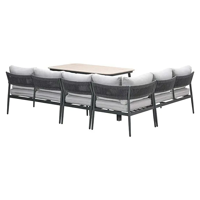 Garden Impressions Loungemöbel-Set Barcelona -  - Dunkelgraues Metall- und Flecht-Gartenecksofa mit hellgrauen Kissen, dazu ein rechteckiger Tisch aus hellem Holz.