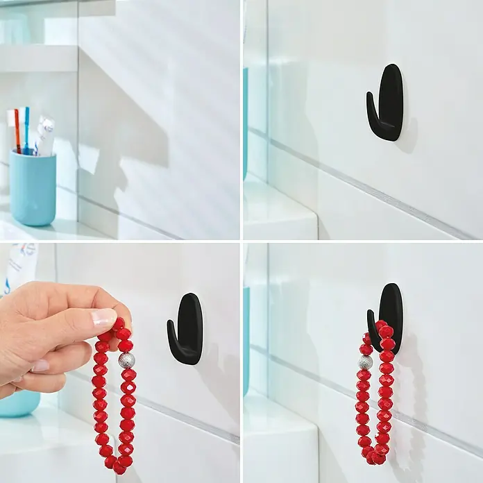 Tesa Powerstrips Selbstklebehaken - Oval, Größe: S, Schwarz, 3 Stk. - Das Bild zeigt einen schwarzen Command Haken an einer weißen Badezimmerwand, zuerst leer, dann mit einem roten Armband.