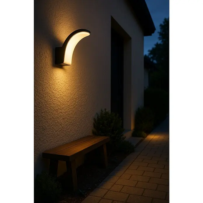 Eglo Aplique exterior LED Lanconella-E - 11,5 W, 7 x 7 x 18 cm, Negro, Blanco, IP44 - Lámpara de pared LED moderna que ilumina la pared de una casa junto a un banco de madera y un camino pavimentado al aire libre.