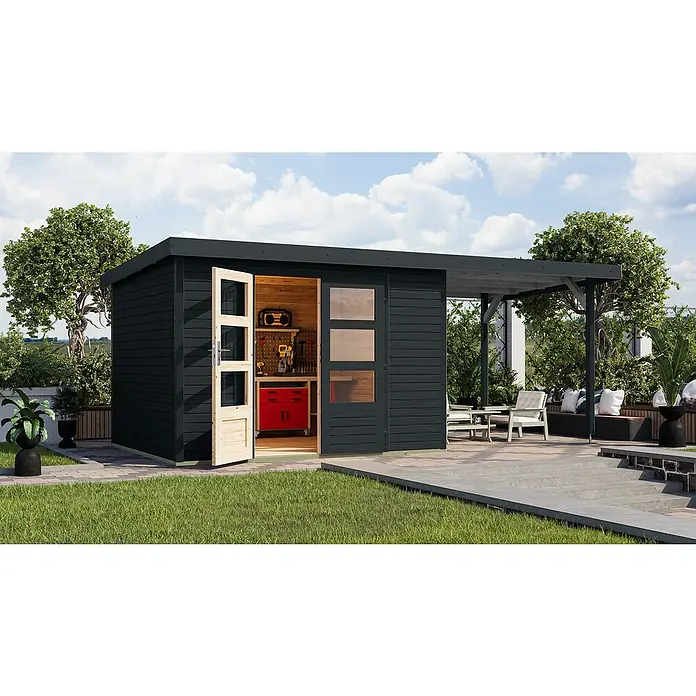 Karibu Gartenhaus Jupiter 5 C - Außenmaß inkl. Dachüberstand (B x T): 541,5 x 266,5 cm, Holz, Anthrazit, Mit Seitendach - Ein modernes Gartenhaus mit offenem Holztor, Werkbank und Überdachung, umgeben von Grün. Ideal für Hobbygärtner und Handwerker.