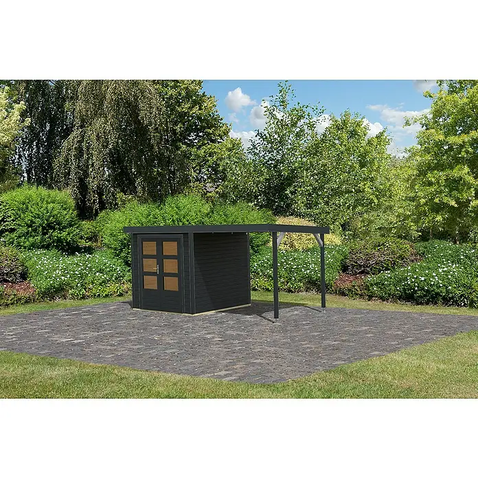 Karibu Gartenhaus Jupiter 2 C - Außenmaß inkl. Dachüberstand (B x T): 453 x 235 cm, Holz, Anthrazit - Modernes Gartenhaus mit Anbau und dunkler Holzfassade auf gepflasterter Fläche im Grünen. Praktische und stilvolle Ergänzung für jeden Garten.
