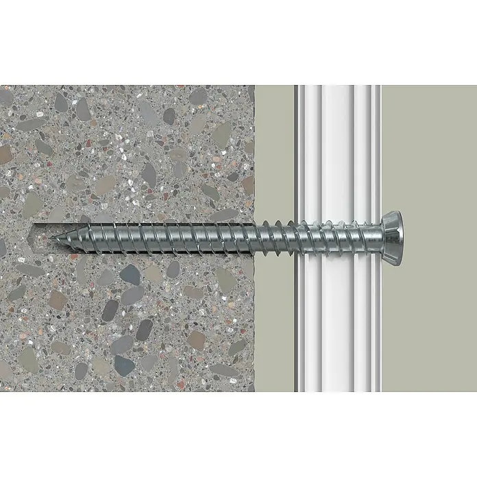 Solid Elements Montageschrauben - Länge: 182 mm, Passend für: Fenster- und Türenmontage, 50 Stk. - Nahaufnahme einer Schraube, die in eine Wand mit Betonoptik geschraubt wird, um eine weiße Leiste zu befestigen.