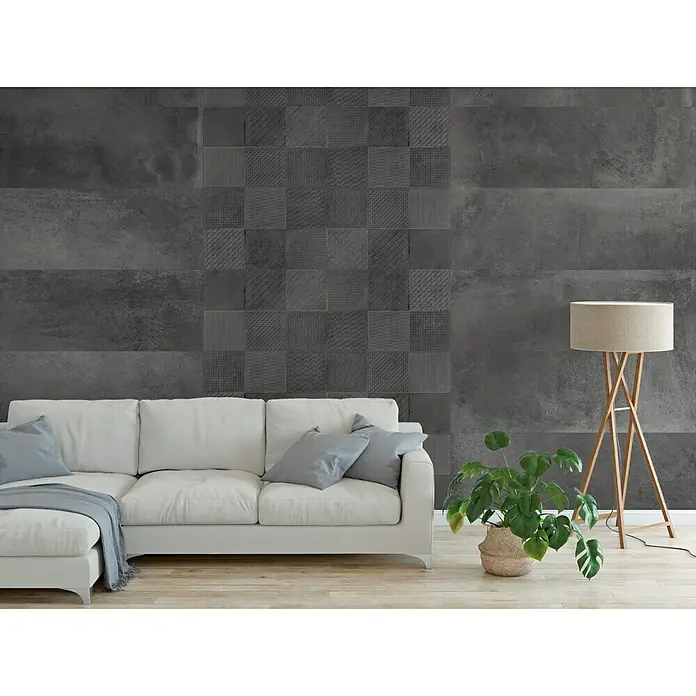 Revestimiento de pared Madox - 30 x 90 cm, Antracita, Mate, Rectificado - Salón con sofá moderno y fondo de azulejos gris oscuro que crean un ambiente elegante.