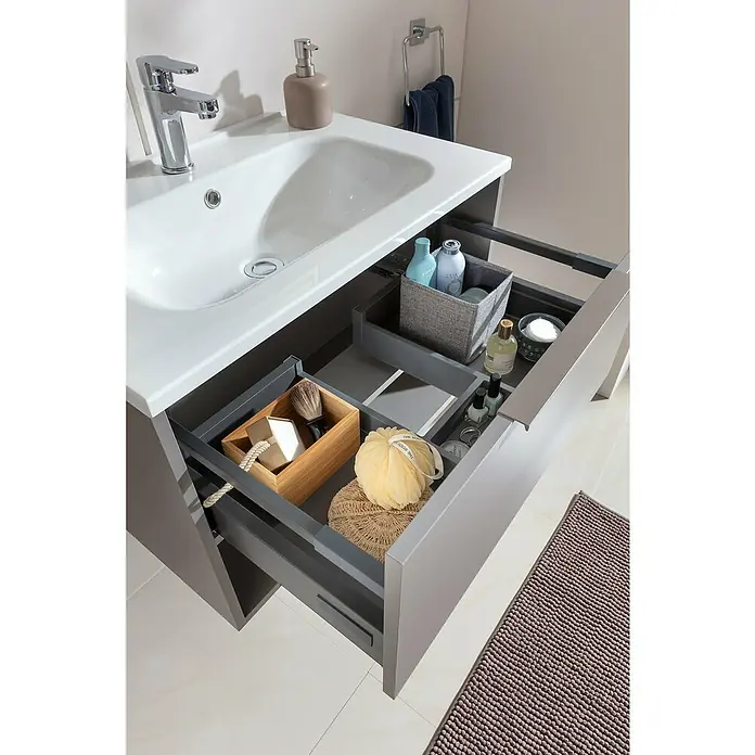Fackelmann B.Paris Badmöbel-Set - Gesamtbreite Badmöbel: 70,5 cm, Cubanit grau, Material Waschbecken: Marmorguss - Ein Badezimmerwaschtisch in Grau mit einer offenen Schublade, die eine Vielzahl von Badezimmerartikeln wie Seife und Lotionen zeigt.