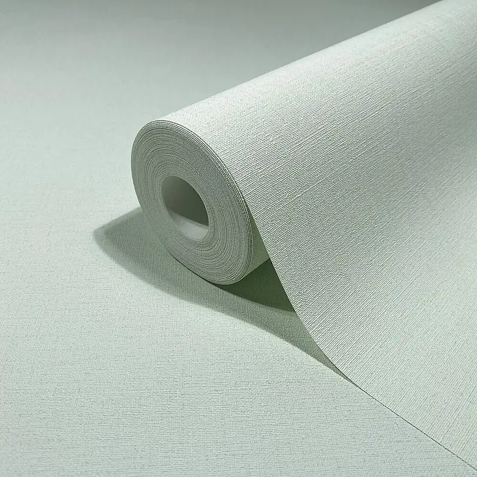 Glööckler Pompöös Provence Vliestapete - Pastellgrün, Uni, 10,05 x 0,53 m - Nahaufnahme einer Rolle hellgrüner Leinwandtapete, die die Textur und Farbe des Produkts hervorhebt.