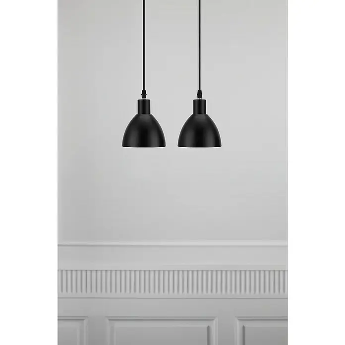 Nordlux Ray Lámpara colgante redonda - 80 W, Ø x Al: 12 x 16,5 cm, Negro, E14 - Dos elegantes lámparas colgantes negras mate con un diseño sencillo cuelgan frente a una pared blanca con molduras decorativas, añadiendo un toque moderno.