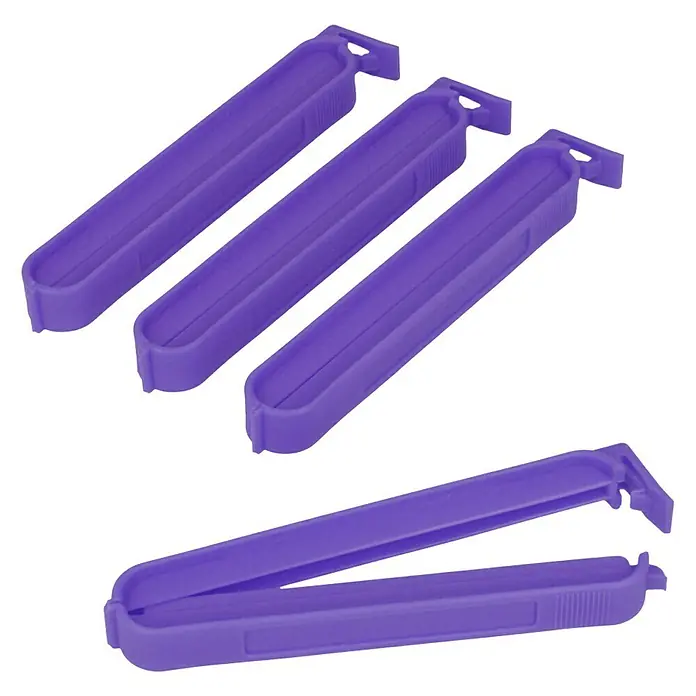 Metaltex Clips - 4 Stk., L x B x H: 11 x 1,2 x 1,5 cm - Nahaufnahme von vier violetten Frischhalteklammern, von denen eine geöffnet ist, um ihre Funktionsweise zu demonstrieren.