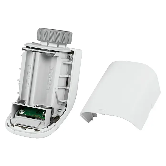 Homematic IP Starter-Set Heizen Easy Connect - 1 x Heizkörperthermostat, 1 x Fenster- und Türkontakt, 1 x Adapter Danfoss RA, 1 x Stützring, 1 x Montagematerial, 4 x Batterien, 1 x Bedienungsanleitung - Ein geöffneter, weißer Heizkörperthermostat, der das Batteriefach zeigt. Der Deckel liegt daneben.