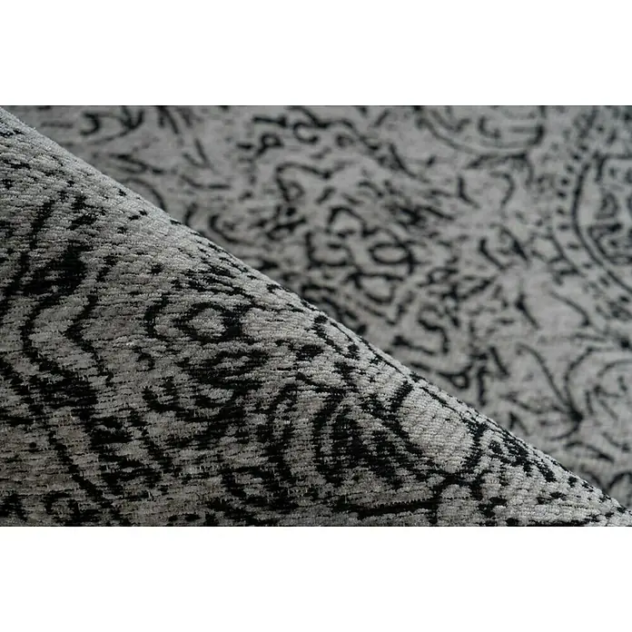 Kayoom Kurzflorteppich Iglesia - Grau/Schwarz, 290 x 200 cm, 100 % Polyester - Nahaufnahme eines stilvollen grauen Teppichs mit einem abstrakten schwarzen Muster, der Textur und Design hervorhebt.
