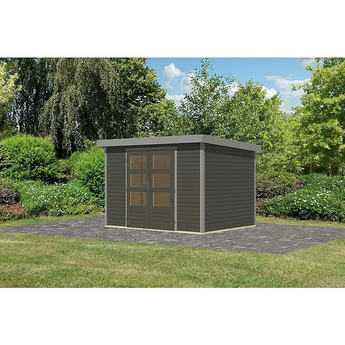 Karibu Gartenhaus Jupiter 4 B - Außenmaß inkl. Dachüberstand (B x T): 322 x 236,5 cm, Holz, Terragrau/Grau - Das Bild zeigt ein Gartenhaus mit Doppeltür und Flachdach, umgeben von Grünflächen. Das Haus steht auf einem gepflasterten Untergrund.