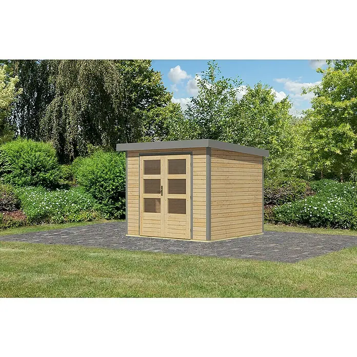 Karibu Gartenhaus Jupiter 3 A - Außenmaß inkl. Dachüberstand (B x T): 266 x 236,5 cm, Holz, Naturbelassen/Grau - Gartenhaus aus Holz mit Doppeltür und grauem Flachdach, umgeben von Grünfläche und Bäumen.