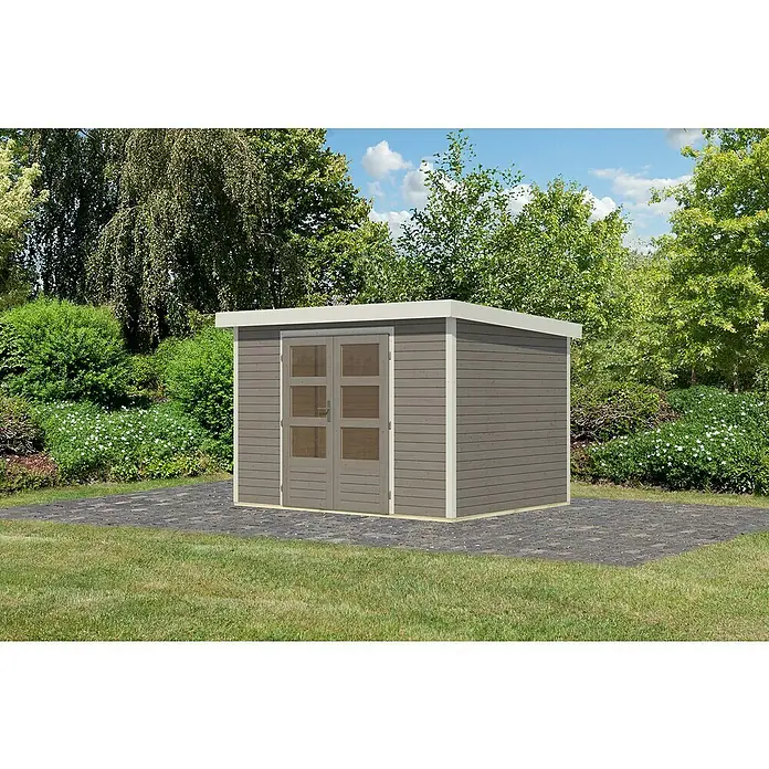 Karibu Gartenhaus Jupiter 4 D - Außenmaß inkl. Dachüberstand (B x T): 322 x 236,5 cm, Holz, Wassergrau/Weiß - Abbildung eines grauen Gartenhauses mit weißen Akzenten und Doppeltüren auf gepflastertem Untergrund, umgeben von Grün.