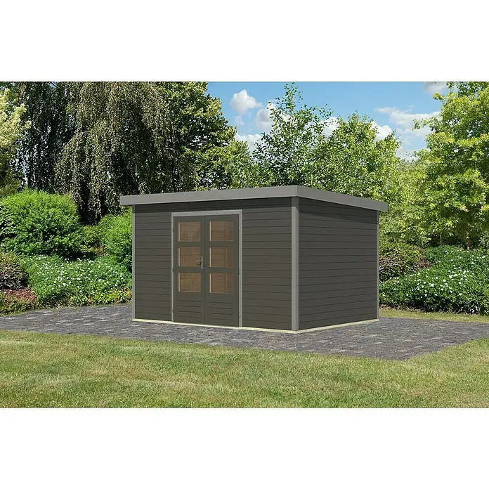 Karibu Gartenhaus Pluto 7 B - Außenmaß inkl. Dachüberstand (B x T): 390 x 273 cm, Holz, Terragrau/Grau - Foto eines modernen Gartenhauses in Anthrazit mit Flachdach und Glastür, umgeben von Grünpflanzen.