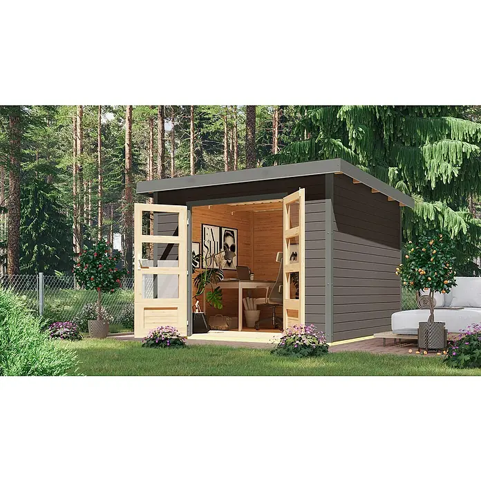 Karibu Gartenhaus Pluto 6 B - Außenmaß inkl. Dachüberstand (B x T): 309 x 292,4 cm, Holz, Terragrau/Grau - Das Bild zeigt ein modernes Gartenhaus mit offenstehenden Türen, das als Büro genutzt wird, umgeben von Grün.