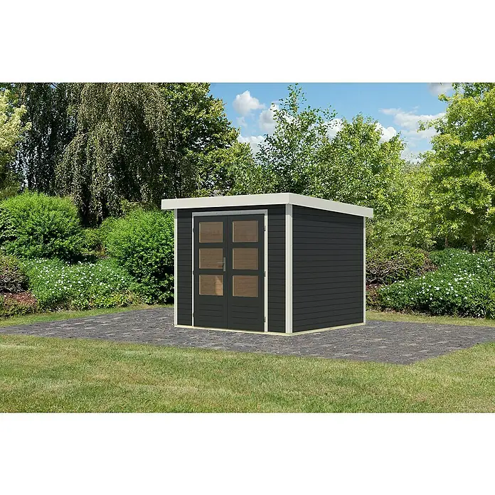 Karibu Gartenhaus Jupiter 3 C - Außenmaß inkl. Dachüberstand (B x T): 266 x 236,5 cm, Holz, Anthrazit/Weiß - Ein modernes Gartenhaus mit dunkelgrauer Fassade und weißen Akzenten vor üppigem Grün.