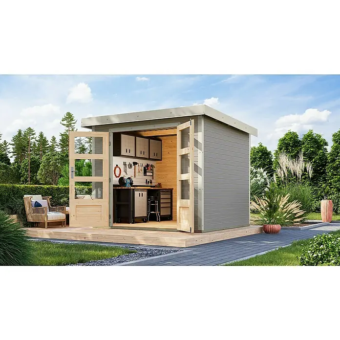 Karibu Gartenhaus Jupiter 3 D - Außenmaß inkl. Dachüberstand (B x T): 266 x 236,5 cm, Holz, Wassergrau/Weiß - Moderne Gartenlaube mit Werkbank und offenen Holztüren auf einer Holzterrasse. Das graue Äußere harmoniert mit der grünen Umgebung.