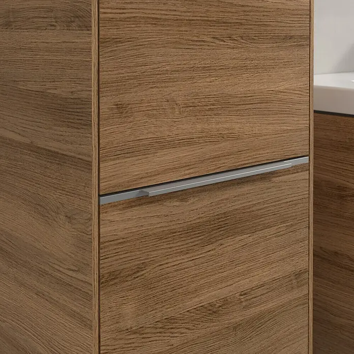 Villeroy & Boch Subway 3.0 Hochschrank - B x T x H: 40 x 36,2 x 171 cm, 2x Tür, Kansas Oak, Farbe Griff: Aluminium glänzend, DIN Anschlag: Links - Detailaufnahme eines Waschtischunterschranks mit Holzstruktur und einem schlichten, silberfarbenen Griff. Elegantes Design für moderne Badezimmer.