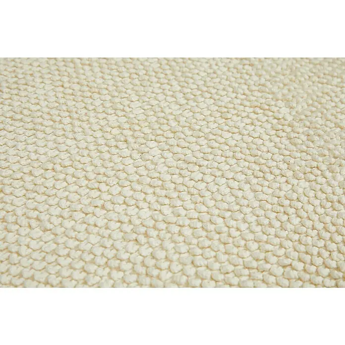 Badteppich Atlanta - 50 x 80 cm, Weiß, 100% Baumwolle - Nahaufnahme eines beigen Teppichs mit einem einzigartigen, strukturierten Design. Ein weiches und einladendes Element für jeden Raum.