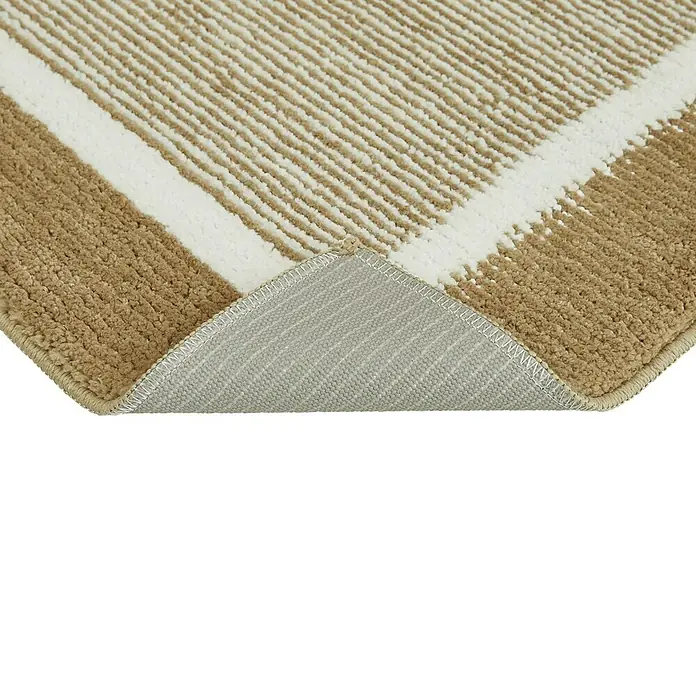 Badteppich Maui - 50 x 80 cm, Taupe, 100% Polyester - Detailaufnahme eines Teppichs mit beigen und weißen Streifen, der auf der Rückseite liegt und die graue Unterseite zeigt.