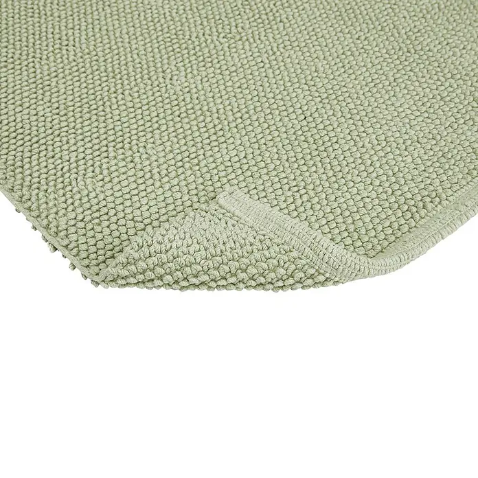Badteppich Atlanta - 50 x 80 cm, Salbei, 100% Baumwolle - Detailansicht einer hellgrünen Badematte mit Noppenstruktur und sauber vernähten Kanten, ideal für ein stilvolles Badezimmer.