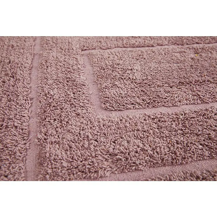 Badteppich Havanna - 50 x 80 cm, Rostrot, Border, 80% Baumwolle, 20% Polyester - Nahaufnahme eines lilafarbenen Badteppichs mit quadratischem Design. Der Teppich hat eine weiche, flauschige Textur und eine dekorative Bordüre.