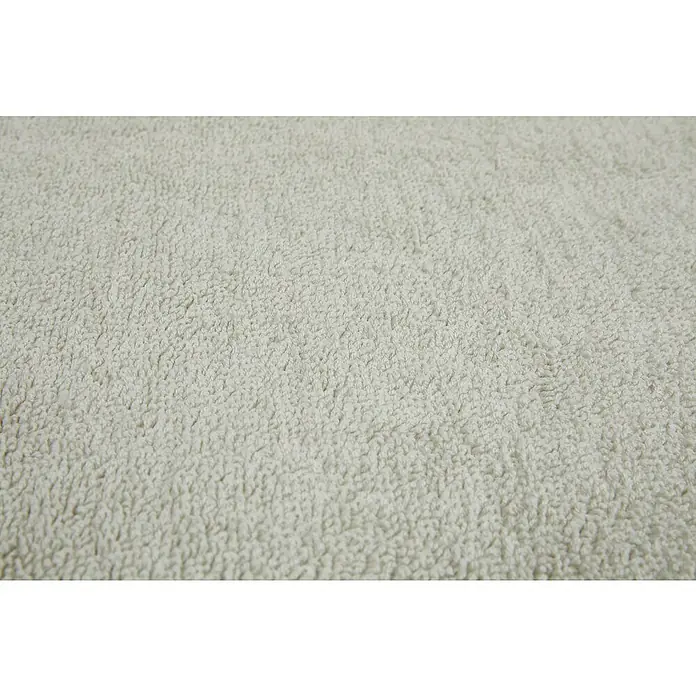 Badteppich Malibu - 60 x 100 cm, Beige, 100% Polyester - Nahaufnahme eines hellen, flauschigen Frotteehandtuchs. Die Textur des weichen Stoffes ist gut erkennbar. Ideal für Bad oder Küche.