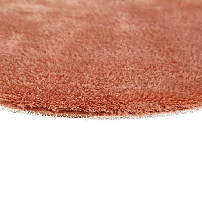Badteppich Florida - 60 x 60 cm, Rostrot, 100% Polyester - Detailaufnahme eines runden, pfirsichfarbenen Teppichs mit weicher Textur und sauberer, weißer Umrandung.