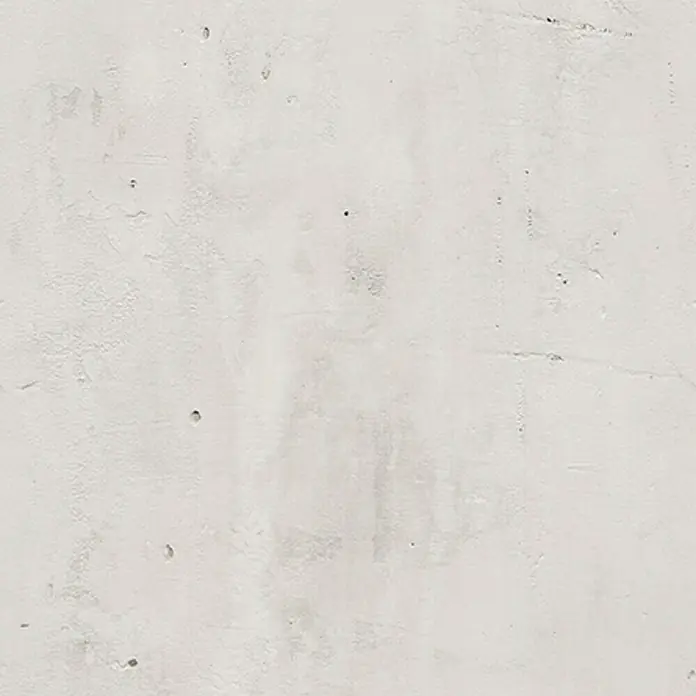 Grosfillex Wandpaneel Element 3D - Beton New York Weiss, 2.600 x 375 x 8 mm - Nahaufnahme einer hellen Betonwand mit subtilen Texturen und Unregelmäßigkeiten, die dem Material Charakter verleihen.