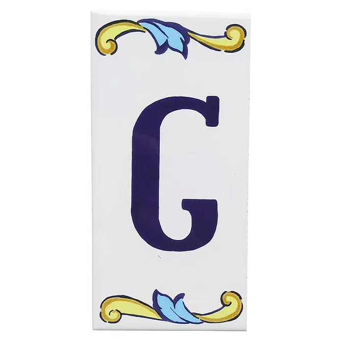 Pavimento cerámico Letra G - 7,5 x 15 cm, Blanco/Azul/Amarillo, Brillante - Azulejo decorativo con la letra G, adornado con diseños florales amarillos y azules, ideal para personalizar paredes.