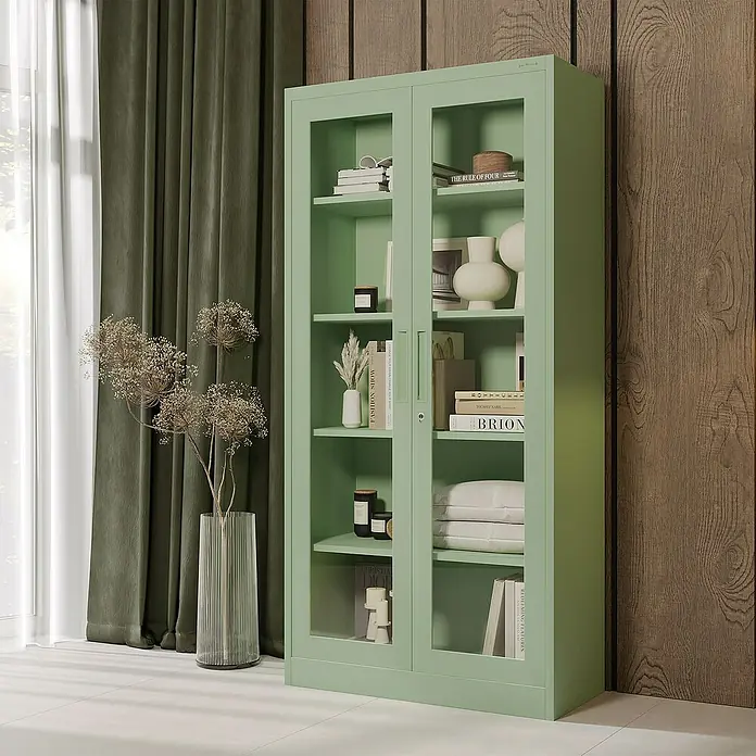 Jan Nowak Aktenschrank Amelia - B x T x H: 90 x 40 x 185 cm, Grün - Ein grüner Bücherschrank mit Glastüren steht in einem stilvollen Raum und bietet Stauraum für Bücher und Dekoartikel.