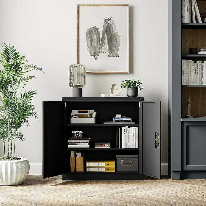 Jan Nowak Aktenschrank Beata - B x T x H: 90 x 40 x 92,5 cm, Schwarz - Ein offener, schwarzer Büroschrank mit zwei Regalen, gefüllt mit Büchern, Ordnern und verschiedenen Gegenständen, der eine organisierte Arbeitsatmosphäre schafft.