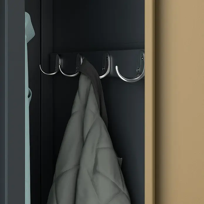 Jan Nowak Spind Kacper - H x B x T: 180 x 80 x 50 cm, Anthrazit/Nussbaum, Anzahl Türen: 2 Stk., Anzahl Fächer: 4 Stk. - Nahaufnahme von einem grauen Mantel, der an einem der Chromhaken in einem dunklen Kleiderschrank hängt.