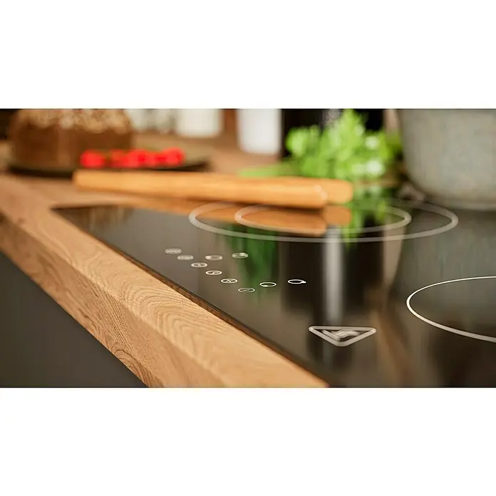 BAUHAUS Winkelküche Sandra - B x T: 280 x 170 cm, Grau, Matt, Farbe Korpus: Artisan Eiche, Mit Elektrogeräten - Nahaufnahme eines modernen Induktionskochfelds mit elegantem Design, integriert in eine hölzerne Arbeitsplatte.