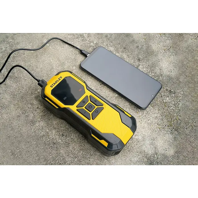DeWalt Akku-Luftpumpe SXIF0101 - 11,1 V, 10 bar, Füllleistung: 14,2 l/min - Ein gelb-schwarzer Stanley-Akku-Pack lädt ein Smartphone auf einem grauen Untergrund. Kompaktes Design mit diversen Funktionen.