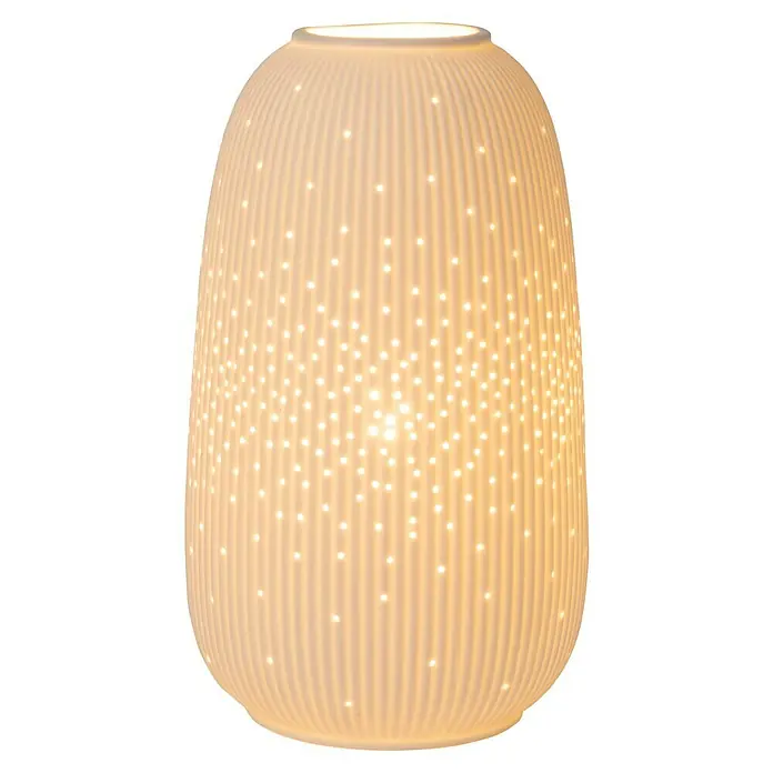 Lucide Deko-Tischleuchte - 25 W, L x B x H: 19 x 14,1 x 24,1 cm, Weiß, E14 - Nahaufnahme einer beleuchteten, geriffelten Lampe mit dekorativen Löchern.