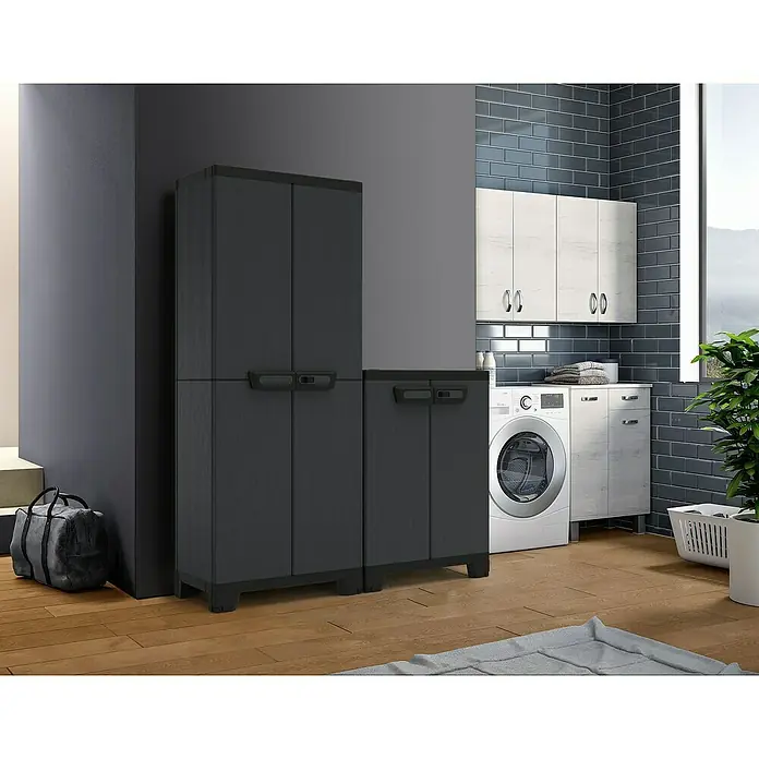 Terry Armario multiusos de plástico  Ardesia - Gris oscuro/Negro, 2 piezas - En la imagen se ve un armario de plástico gris con dos puertas, ideal para lavadero o almacén. Ofrece un espacio de almacenamiento práctico.