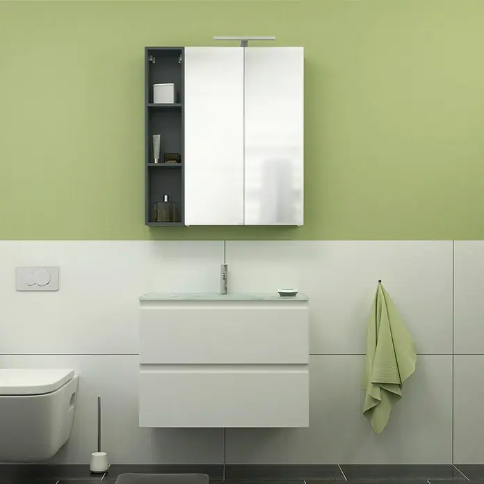 Camargue Espacio Badmöbel-Set G62 - 80 cm, Gama weiß matt - Badezimmer-Interieur mit einem modernen Waschbeckenunterschrank in Weiß, einem Spiegelschrank und einem WC. Der Raum ist in Grün- und Weißtönen gehalten.