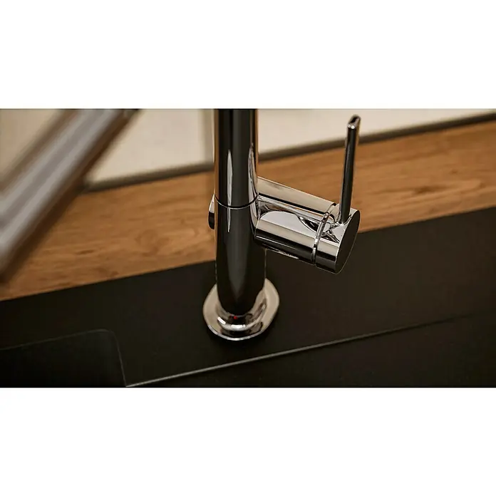 Hansgrohe Grifo de cocina Talis M54 270 - Cromo, Brillante - Primer plano de un elegante grifo de cocina cromado montado sobre una encimera oscura, destacando su diseño moderno y funcionalidad.