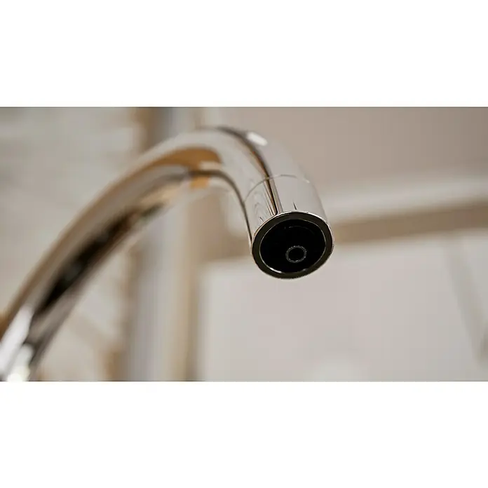 Grohe Spültischarmatur Blue Home Mono - Höhe: 37,9 cm, C-Auslauf, Chrom, Glänzend, Schwenkbar - Nahaufnahme eines glänzenden Chrom-Wasserhahns mit einem fokussierten Blick auf die Öffnung, die die Präzision und das moderne Design hervorhebt.