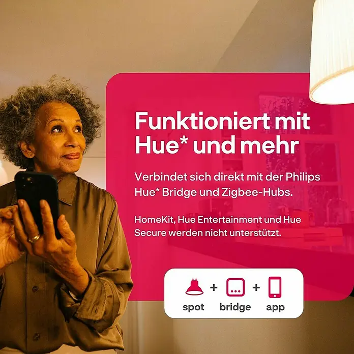 Innr Lighting Smart-LED-Lampen Set Spot White - GU10, Dimmbar, Warmweiß, 460 lm, 4,9 W, 2 Stk. - Frau mit Handy im Vordergrund, Philips Hue Produktwerbung im Hintergrund.