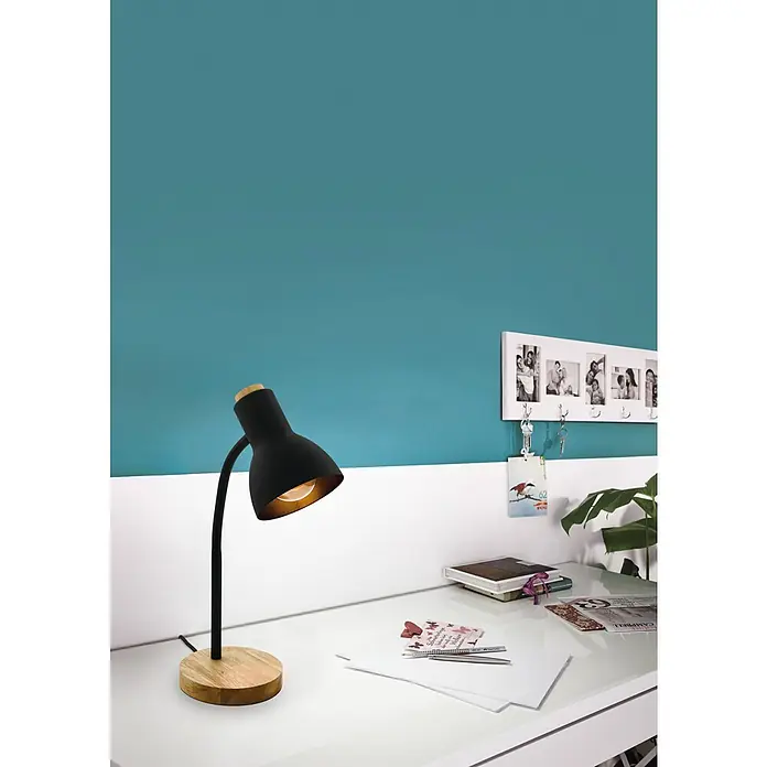 Eglo Lámpara de sobremesa Veradal - 40 W, L x An x Al: 16 x 12,5 x 49 cm, Negro, E27 - Primer plano de una lámpara de escritorio con base de madera sobre un escritorio blanco frente a una pared azul y blanca.